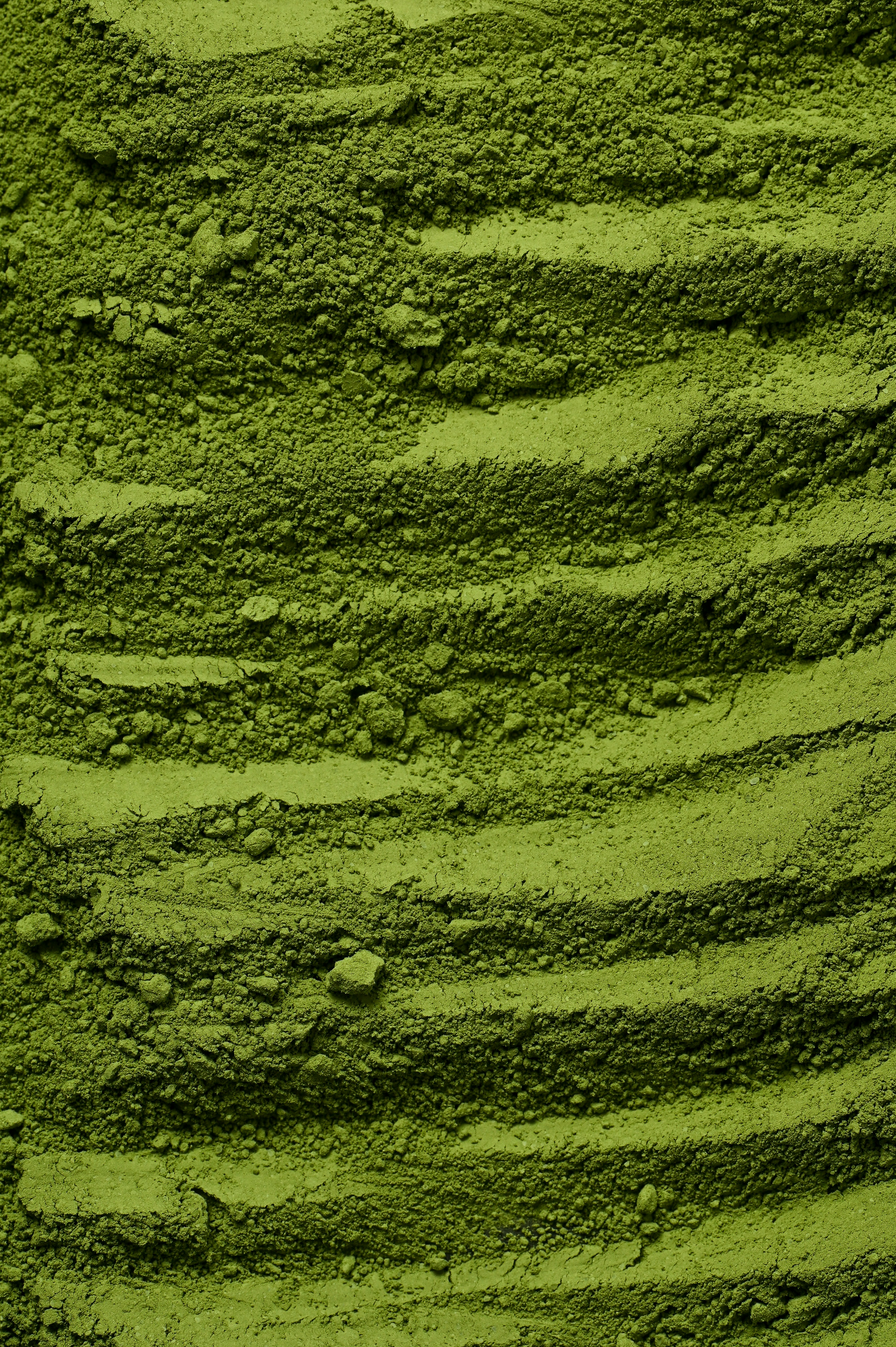 Extreme close-up of vivid green stone-ground matcha powder